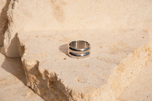 Silver ring on a textured stone surface