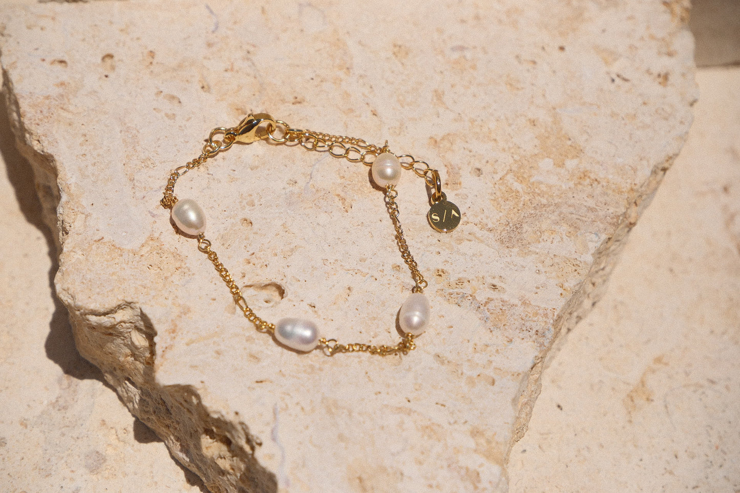 Sol & Aura - Pearla Bracelet - 4 natural pearls on bracelet on thin gold chain on stone surface