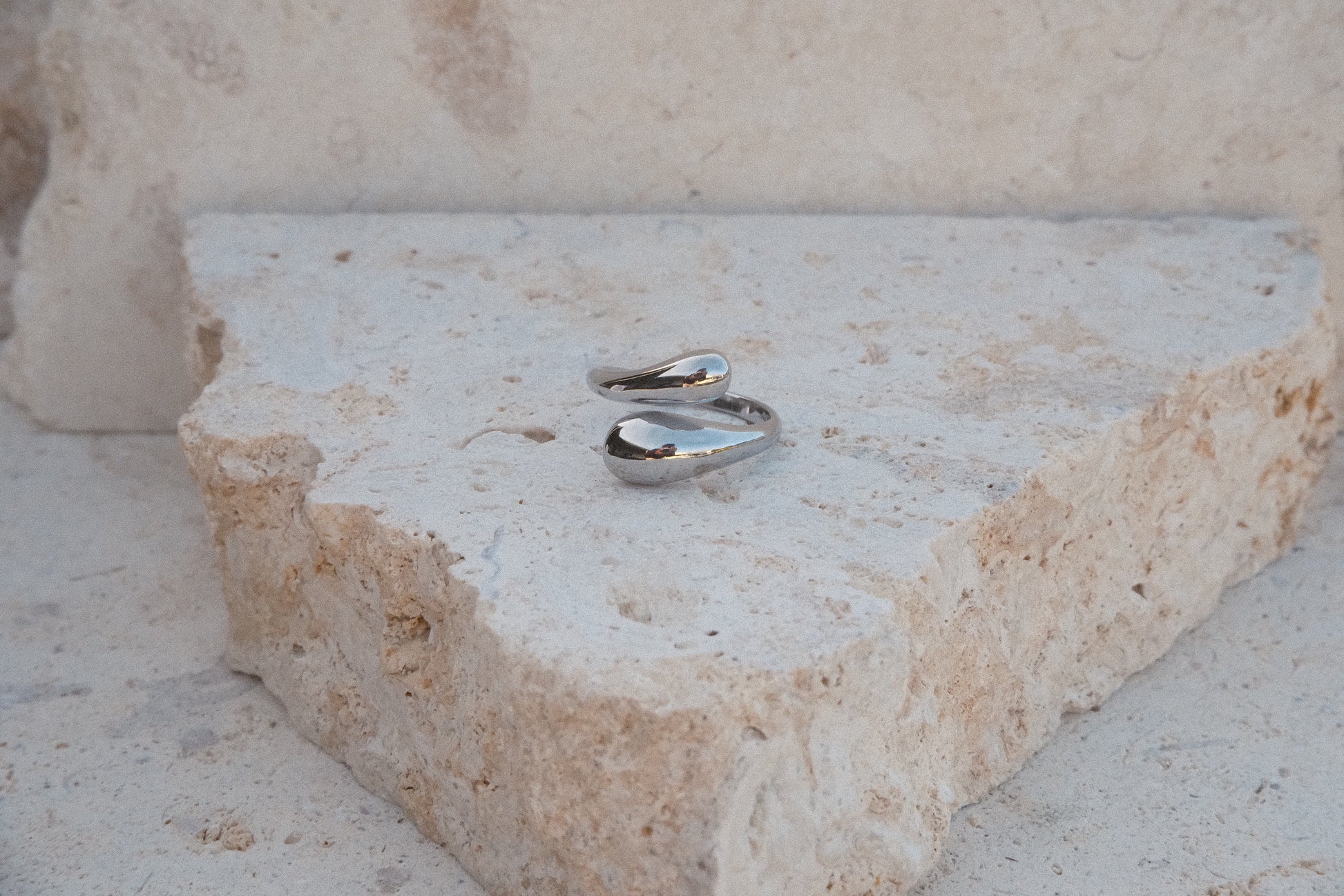 Silver ring on a textured stone surface