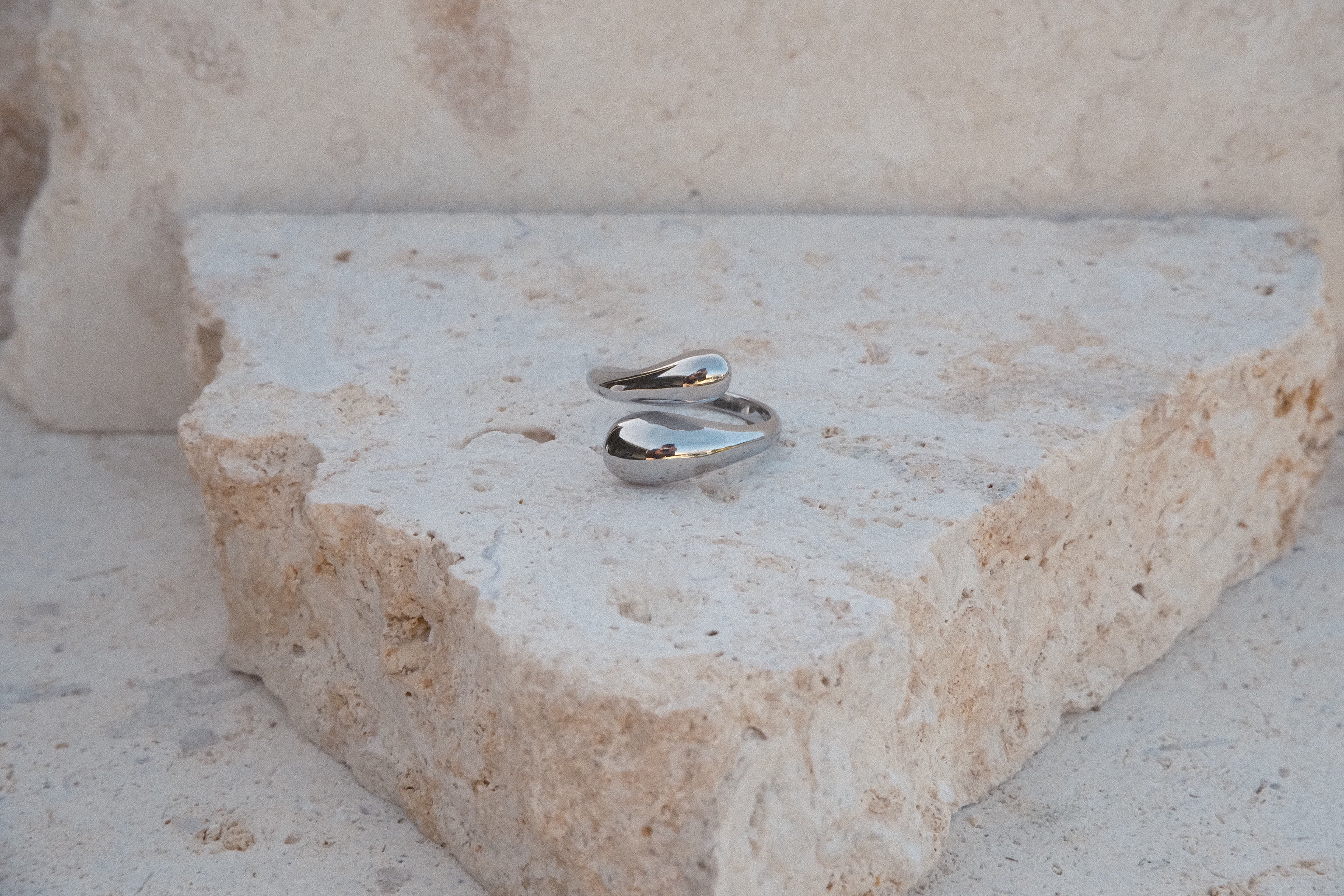 Silver ring on a textured stone surface