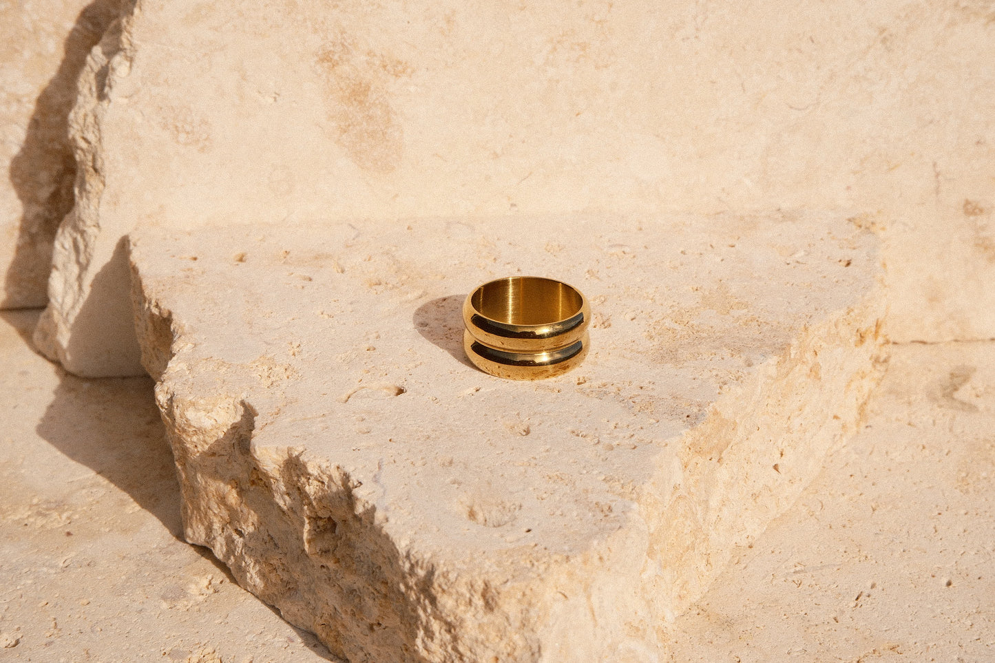 Gold ring on a textured stone surface