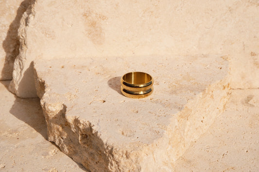 Gold ring on a textured stone surface