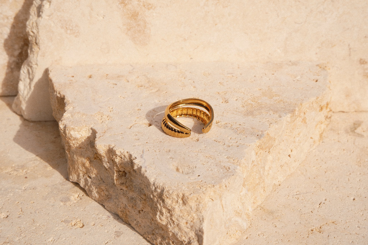 Gold ring on a textured stone surface