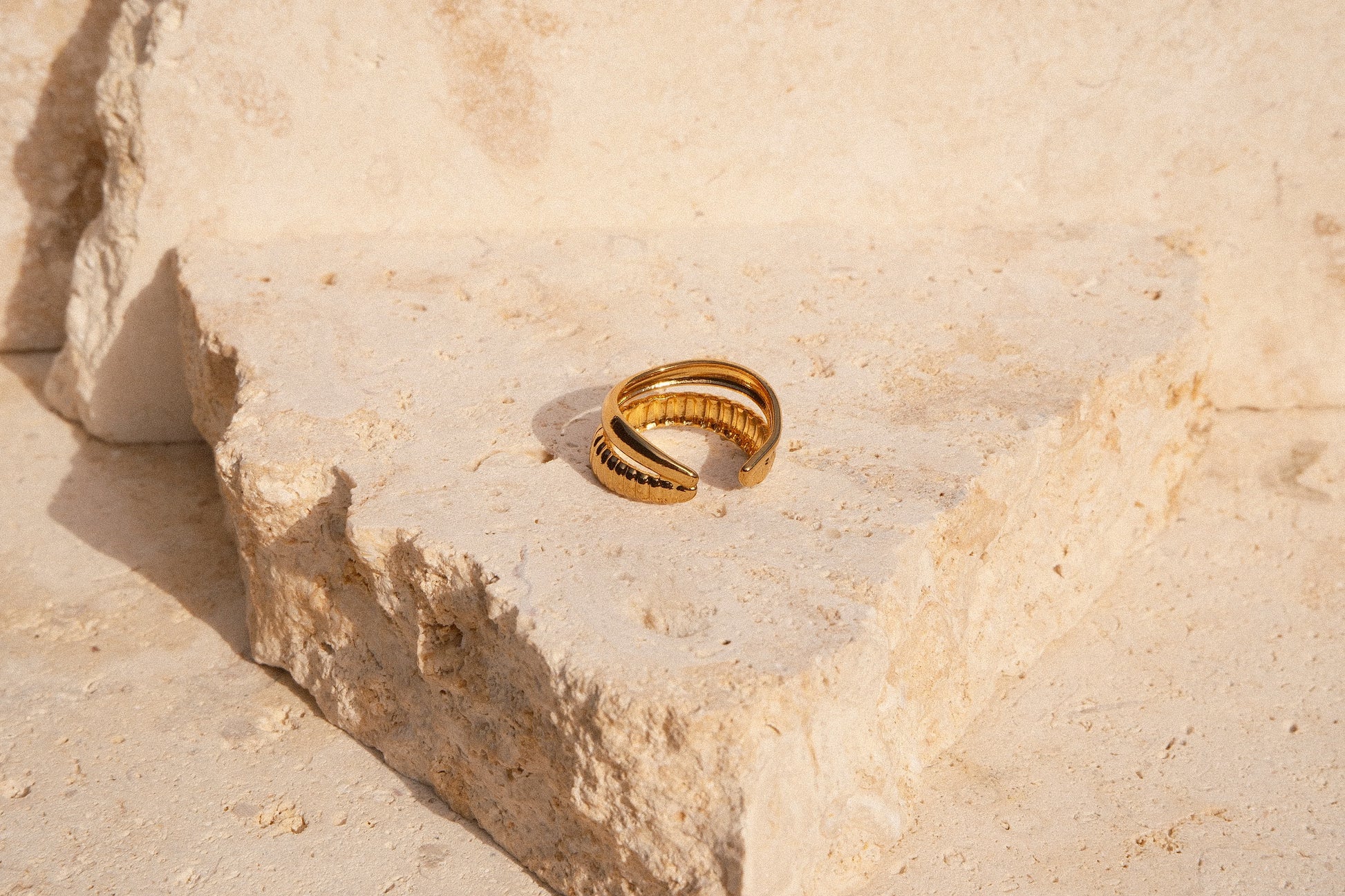 Gold ring on a textured stone surface