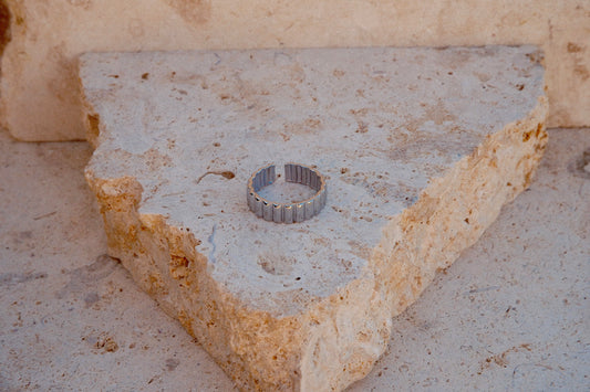 Metallic ring on a textured stone surface