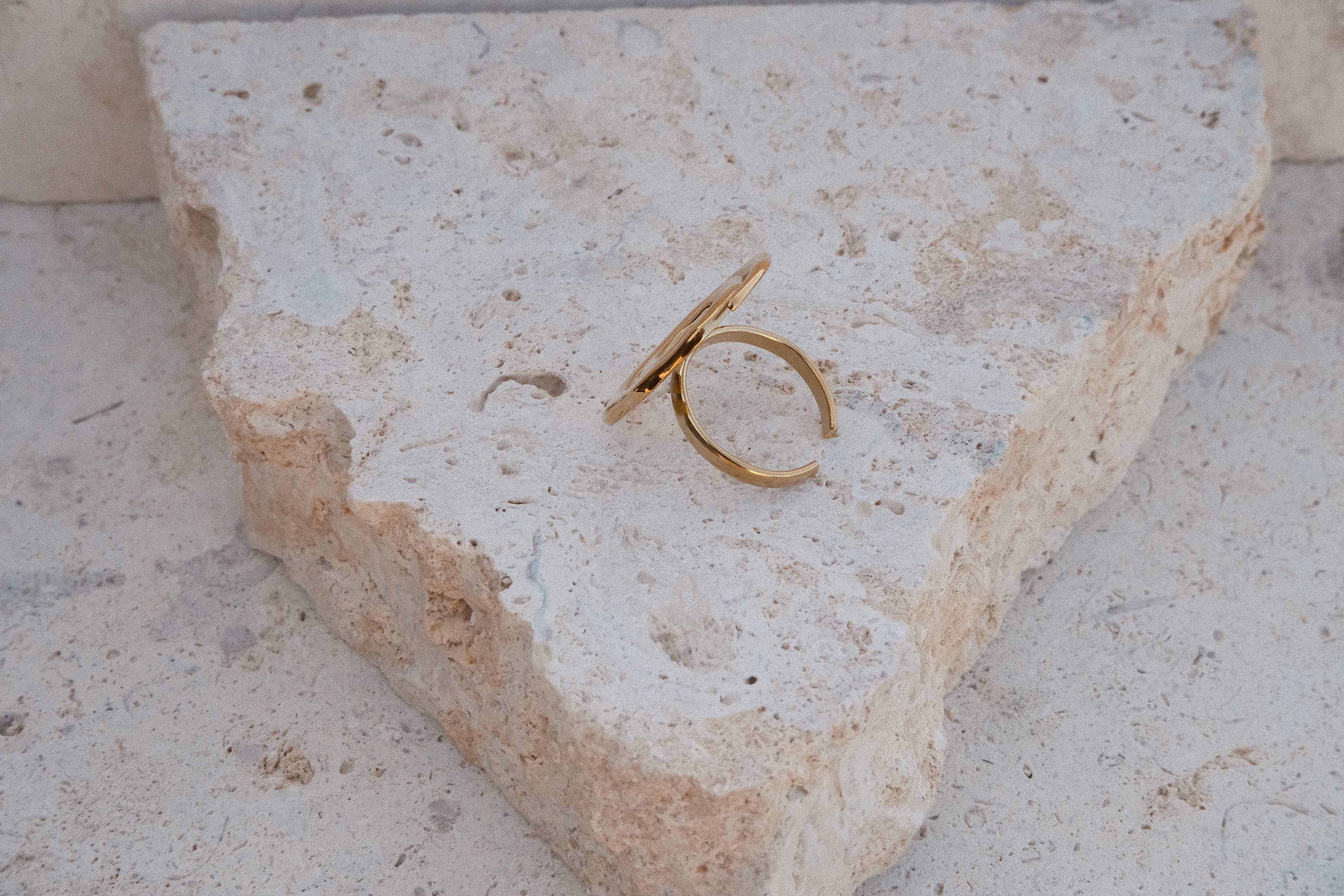Gold ring on a textured stone surface