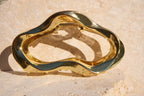Gold claw clip on a textured beige surface