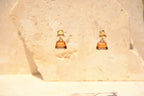 Sol & Aura - Brown and beige glass crystal-like gemstone drop earrings against stone background