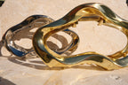 Gold and silver metal clip on a stone surface