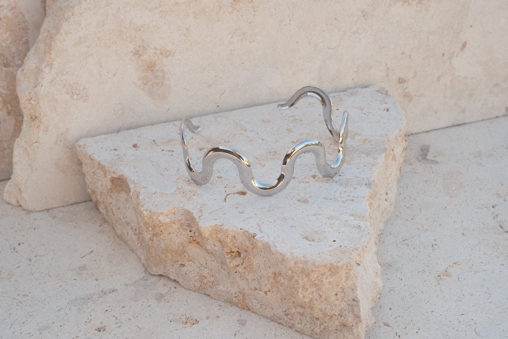 Silver bracelet on a stone surface