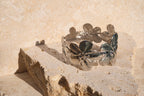 Silver bracelet with leaf designs on a stone surface