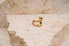 Gold ring on a textured stone surface