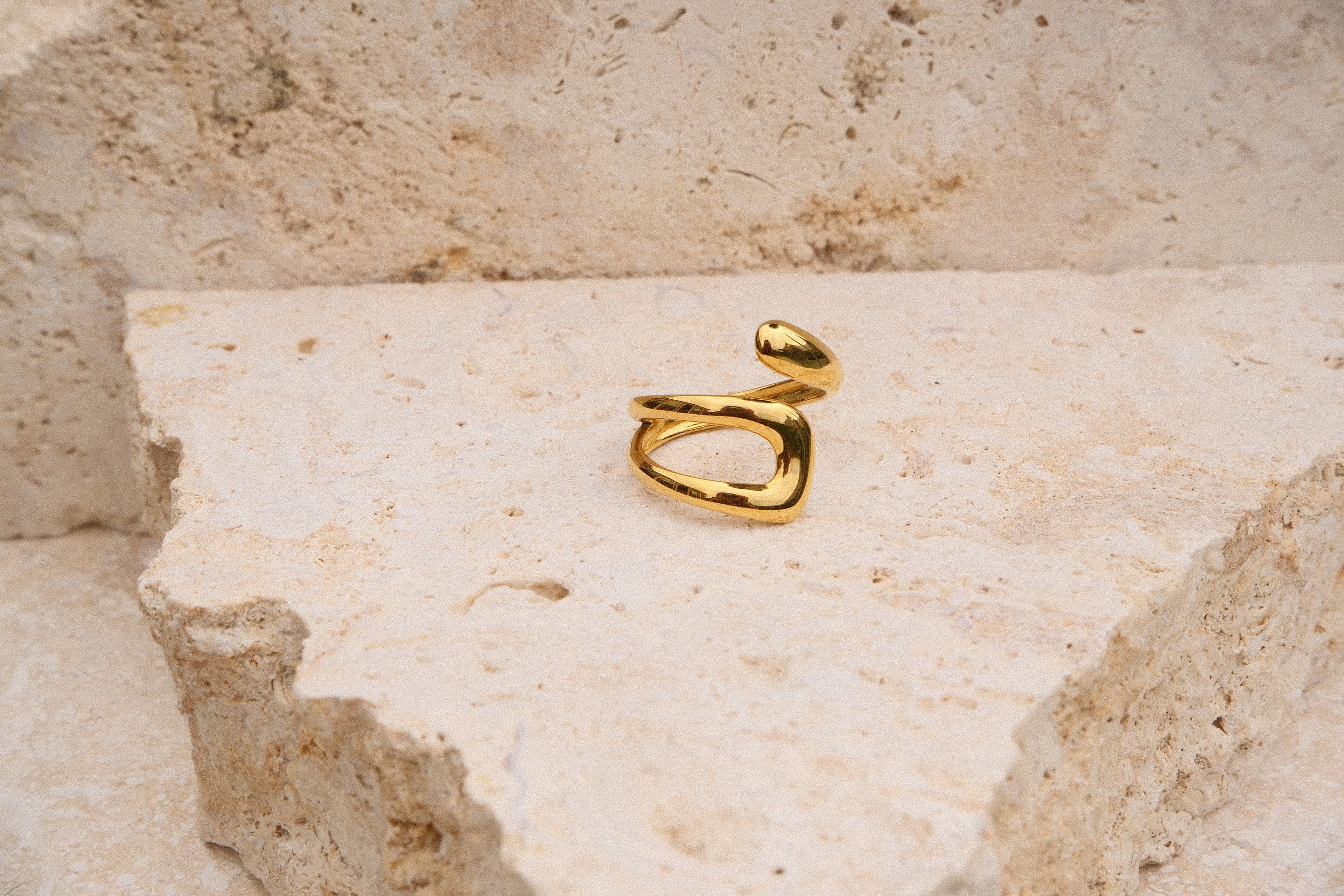 Gold ring on a textured stone surface