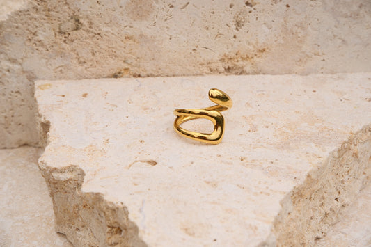 Gold ring on a textured stone surface