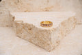 Gold ring on a textured stone surface