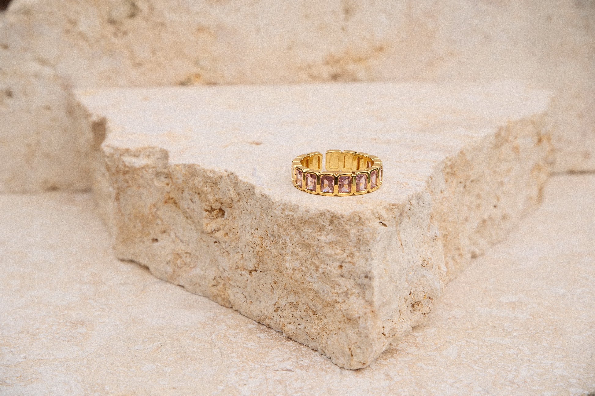 Gold ring on a textured stone surface