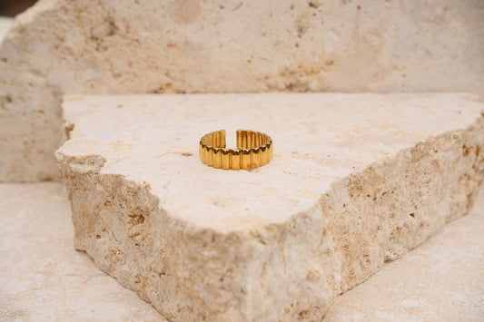 Gold ring on a textured stone surface