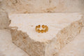 Gold ring on a textured stone surface