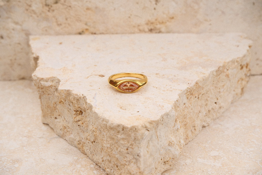 Gold ring on a triangular stone block