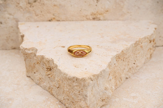 Gold ring on a triangular stone block