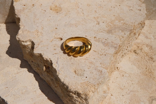 Gold ring on a textured stone surface