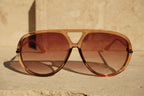 Brown sunglasses with a beige background