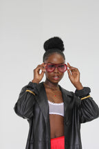 Sol & Aura - FIESTA Sunglasses and DARCI Necklace on woman with black jackt and white bralette 