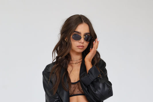 Sol & Aura - Millenia Sunglasses in black being worn by woman in black leather jacket 