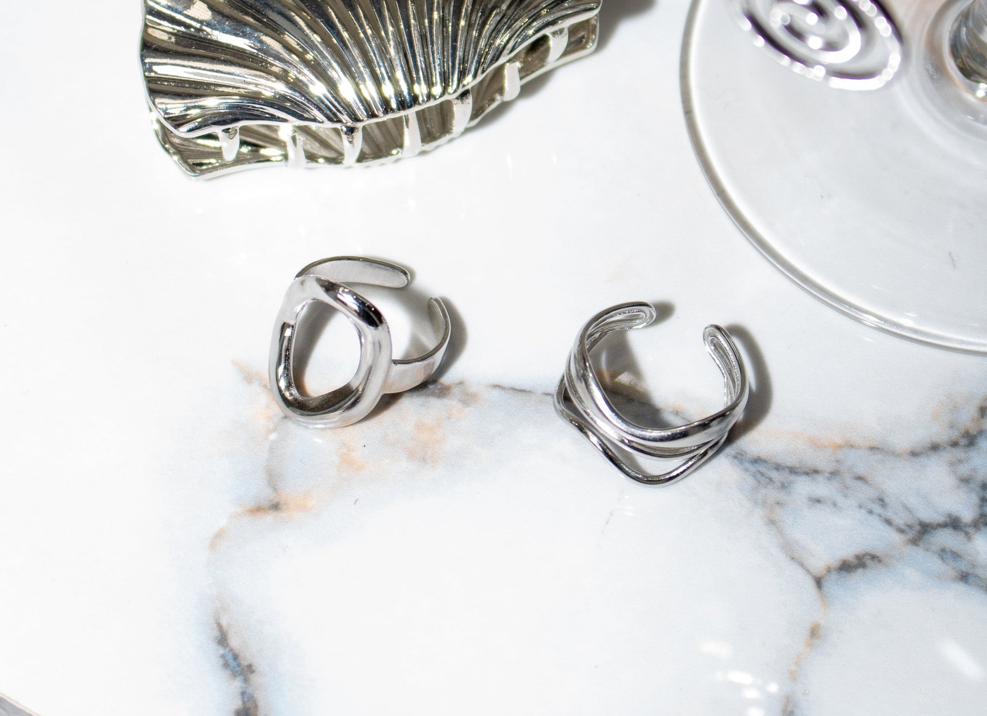 Sol & Aura - 'OH BABY' and 'RIPPLE' rings in silver on marble surface