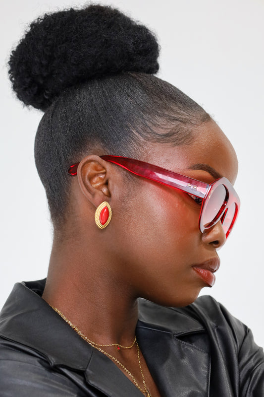 Sol & Aura - Pharaoh Earrings in red on woman wearing red sunglasses with black leather jacket