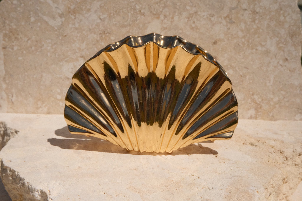 Sol & Aura - Shelly Claw Clip - shell-shaped claw clip on a stone surface with a neutral background