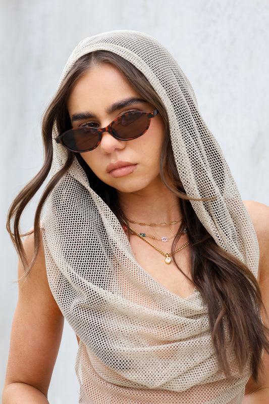 Sol & Aura - Sicily Sunglasses with tortoise shell detailing on woman in mesh hooded top